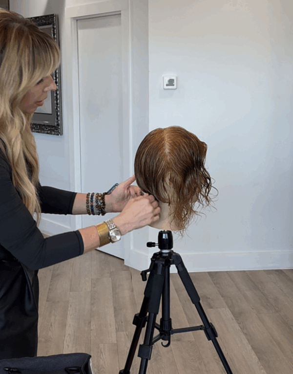 Herta Branding cutting a graduated bob on a mannequin.